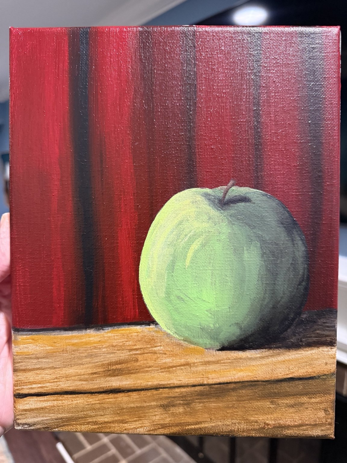 Green apple still life before a red background
